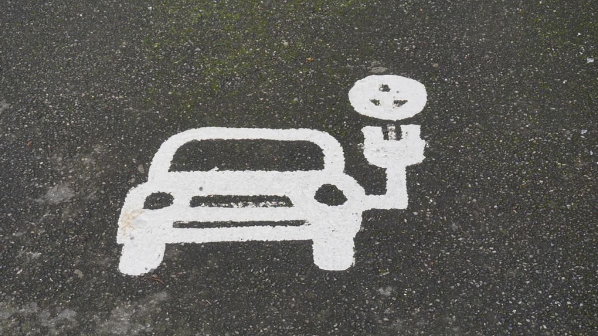 Electric car parking symbol painted on a charging bay
